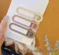 Detailed view of three minimalist matte U-shaped hair clips in neutral earth tones - 3-Piece Matte U-Shaped Clips Set