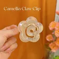 Close-up of a cream camellia flower hair claw clip made of translucent resin material - Camellia Heart Hair Claw