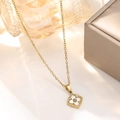 Detailed macro of vintage 18K gold-plated clover necklace with white petal inlay - White Vintage Clover Necklace (836)