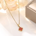 Macro shot of 18K gold plated vintage necklace with red clover leaf pendant in a jewelry box - Red Vintage Clover Necklace (837)