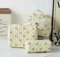 Quilted floral makeup bag set in cream with orange flower patterns and zip handles - Yellow Base Orange Flower