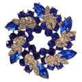 Macro detail of golden bauhinia brooch with deep blue and white crystals on white background - Deep Royal Blue Wreath Style