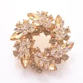Macro detail of luxury champagne crystal wreath brooch with gold leaves and rhinestones - Champagne Wreath Style