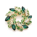 Macro detail of orchid wreath brooch featuring green crystals and gold plating - Olive Green Wreath Style