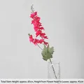 Tall magenta artificial larkspur flower with green leaves in a textured glass vase - Magenta Double-Fork Delphinium