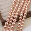 Strands of high-luster round peach pink pearls displayed in a wooden jewelry box - 674 (no. 22) / Approximately 200 Pieces Per Strip 4mm In Size.