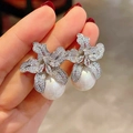 Elegant floral pearl drop earrings featuring silver petals and shimmering crystals - Silver Lily With Large Artificial Pearl Style