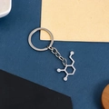 Polished silver dopamine chemical molecule keychain on a minimalist geometric background - Dopamine Molecule Keychain