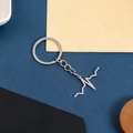 Polished silver heartbeat pulse molecule keychain accessory on colorful geometric background - EKG Heartbeat Keychain