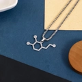 Silver chemical molecular structure pendant necklace on minimalist tri-color background - Dopamine Molecule Necklace