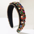 Detailed macro view of colorful rhinestones on a black velvet wide baroque headband - Colorful