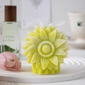 Macro detail of yellow sunflower scented candle with white ribbon and home decor background - Yellow & Green