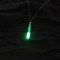 Glow-in-the-dark green hourglass pendant necklace with silver chain on black fabric - Yellow-Green Luminous Hourglass (NY451)