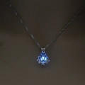 Silver hollow lotus necklace with a luminous blue glowing bead and twisted metal chain - Sky Blue Luminous Lotus (NY056)