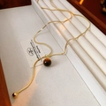 Elegant gold Y-shaped necklace with polished brown tiger eye stone beads on a white box - 23# Gold Style