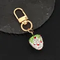 Handmade 3D strawberry keychain with sparkling rhinestones and gold metal hardware - White