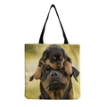 Close-up of canvas tote bag featuring realistic Rottweiler and puppy prints - Rottweiler Adult and Puppy (hm5159)