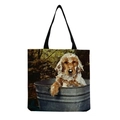 Detail der Canvas-Einkaufstasche mit Golden Retriever-Welpendruck und schwarzen Tragegriffen - Golden Retriever Welpe im Eimer (hm5164)