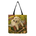 Close-up of golden retriever puppy print on durable canvas tote bag with black straps - Golden Retriever Puppy on Red Chair (hm5172)