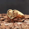 Vintage gold heart signet ring with angel relief on dark wood bark backdrop - US 7 / Gold