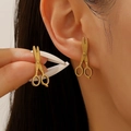 Golden scissor shaped earrings with matte finish shown on a model's ear for style - Scissors Shape (9470)