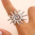 Silver sun-shaped stainless steel ring with spiral sunburst design on model hand - Steel Ring