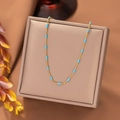 Elegant 18K gold-plated beaded chain necklace with turquoise enamel accents on jewelry box - Rice Gold Beads (H1124) Gold