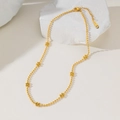 Golden bead chain necklace with floral accents and lobster clasp on white marble base - Seven Flowers (H1018) Gold