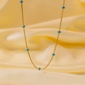 Gold-plated snake chain necklace with vibrant blue beads on soft satin background - Snake Chain Green Bead (H1088) Gold