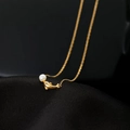 18K gold plated dolphin pendant necklace with a white pearl on black silk fabric - Pearl Dolphin (H1175) Gold