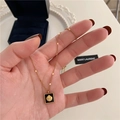 Golden necklace with a black square pendant featuring a 3D gold shell relief design - Black Shell Style (H465) Gold