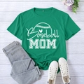 Green Baseball Mom graphic T-shirt with heart design laid flat on wooden background - Dark Green
