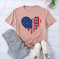 Pink nurse heart T-shirt with American flag pattern and blue jeans on wood background - S / Pink (Black Text)