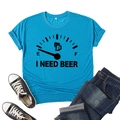 Close-up of I Need Beer graphic print on lake blue cotton t-shirt with flat lay styling - S / Peacock Blue