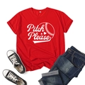 Close-up of Pitch Please print and baseball stitching detail on a red cotton t-shirt - Red