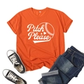 Detail view of orange T-shirt with Pitch Please print styled with denim shorts - Orange