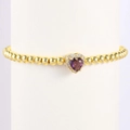 Dettaglio del bracciale a sfere dorate con ciondolo a cuore viola e cornice di cristalli - Aprile-Zirconia Chiara (Stile 04)
