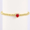 Macro detail of gold beaded bracelet featuring a red heart gemstone and white zircon halo - August-Peridot Green (Style 08)