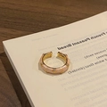 Detailed macro view of an adjustable gold ring with pink enamel and diamond-set floral studs - Style 11 Adjustable Ring