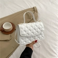 Bolso bandolera acolchado blanco con herrajes dorados y asa superior sostenido a la mano - Blanco