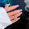 Gold plated water drop necklace with sparkling zircon pendant held by a hand - Gold Water Drop Zirconia Style (W649)
