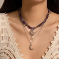 Detail of layered celestial necklaces featuring sun, star, and crescent moon charms - Silver + Purple (4988)