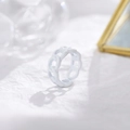 Close-up of a white chain-link open ring with a matte finish on a textured paper background - Adjustable Open / White
