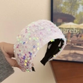Wide headband with colorful sequins and white polka dot lining, held by hand - White Sequin Headband