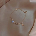 Golden bracelet with star, moon charms, blue bead and pearls on champagne satin fabric - Blue Star Moon Zircon Pearl Bracelet