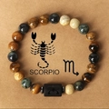 Scorpio beaded bracelet featuring natural tiger eye stones and a black engraved zodiac bead - Scorpio