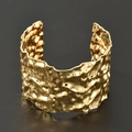 Detailed view of wide gold cuff bracelet featuring irregular hammered lava texture - Irregular Lava Metal Texture (bk030-KC)