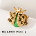 Detailed macro view of a ladybug insect brooch with green gems and gold alloy finish - Green Ladybug (XD8200-1)