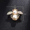 Detail shot of a golden bee brooch with white pearls and sparkling crystal rhinestones - Double Pearl Bee (XD8387)