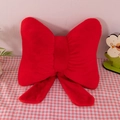 Plush red bow-shaped sofa pillow featuring decorative ribbons and soft faux rabbit fur - Red